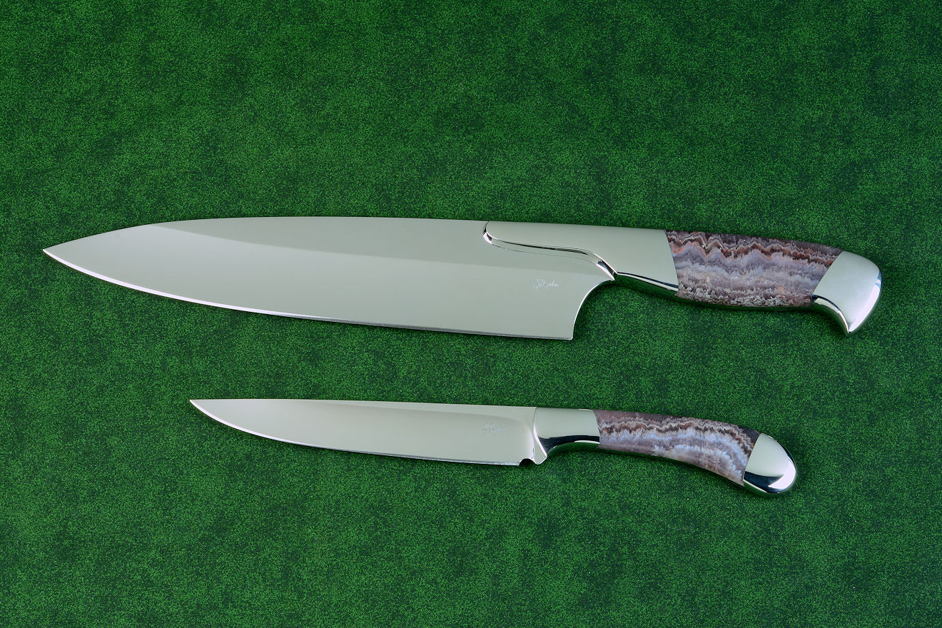 Concordia and Sanchez Chef's knives, obverse side view in T3 cryogenically treated 440C high chromium stainless steel blades, 304 stainless steel bolsters, Lace Amethyst gemstone handles, leather book case with top grain cover