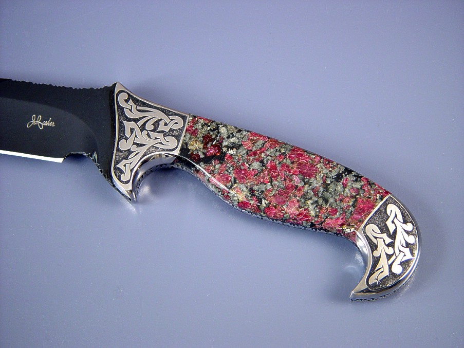 Fine handmade knife: "Mercury Magnum" obverse side view: blued O-1 high carbon alloy tool steel blade, hand-engraved 304 stainless steel bolsters, Eudialite gemstone handle, Elephant skin inalid in hand-carved leather sheath