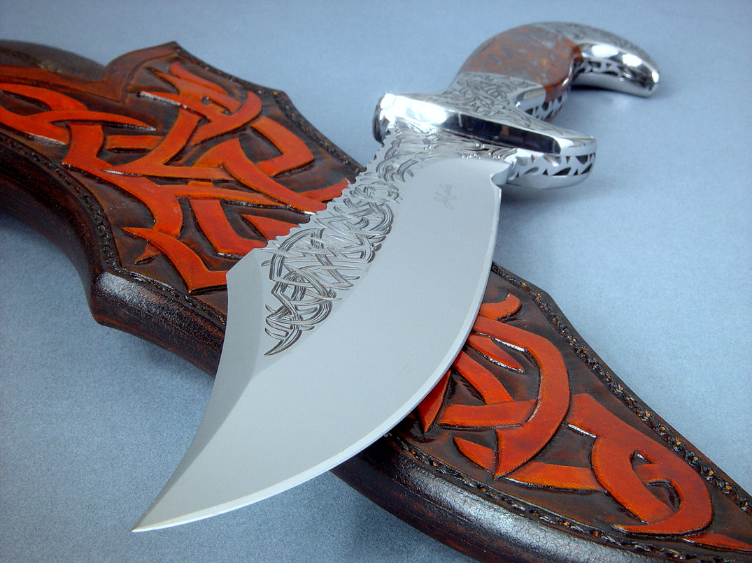 "Tribal" in hand-engraved 440C high chromium stainless steel blade, hand-engraved 304 stainless steel bolsters, Pilbara Picasso Jasper gemstone handle, sheath of hand-carved, hand-dyed leather shoulder, stand of 304 stainless steel, American black walnut, mesquite, lauan hardwoods, engraved black lacquered brass