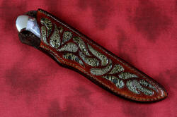 "Opere" sheathed view in 440C high chromium martensitic stainless steel blade, 304 stainless steel bolsters, Bay of Fundy Fossilized Agate gemstone handle, frog skin inlaid in hand-carved leather sheath