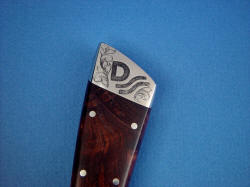 "Rio Grande" obverse side rear bolster detail. Hand-engraved 304 high nickel, high chromium austenitic stainless steel 